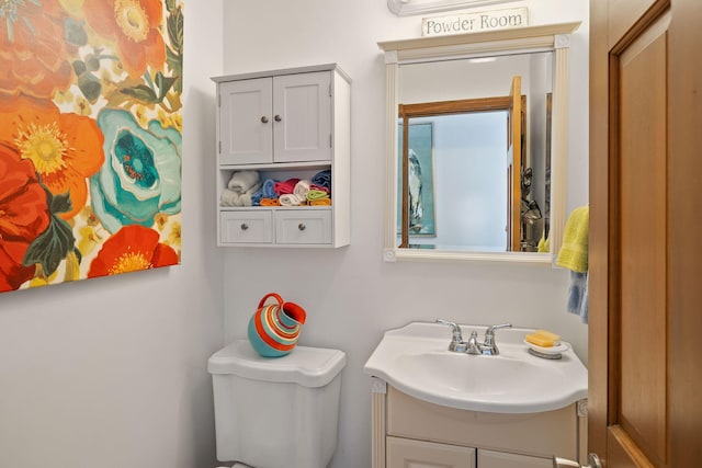 bathroom featuring toilet and vanity