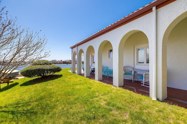 view of yard featuring a patio and a water view