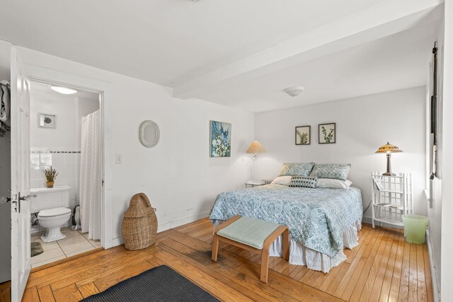 248 N Falmouth Hwy, North Falmouth, MA 02556 - bedroom with ensuite bath, beamed ceiling, and light wood-type flooring