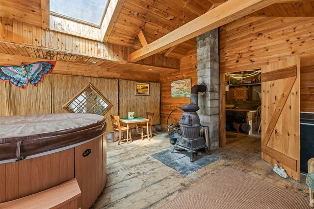 248 N Falmouth Hwy, North Falmouth, MA 02556 - bedroom with wooden walls, wooden ceiling, lofted ceiling with skylight, and a wood stove