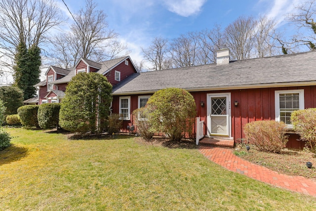 248 N Falmouth Hwy, North Falmouth, MA 02556 - view of front of house featuring a chimney, a front lawn, and board and batten siding