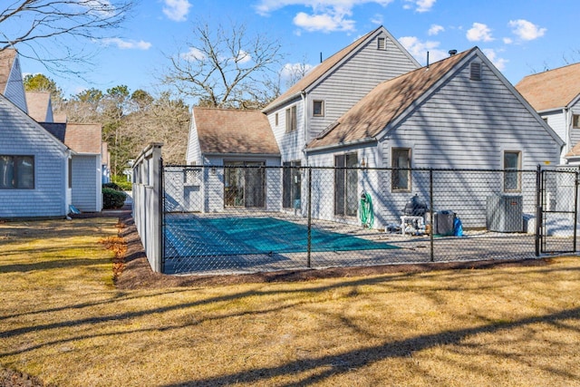 view of pool featuring a lawn, fence, and a gate