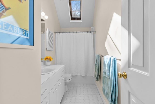 full bath featuring toilet, a skylight, shower / bath combo with shower curtain, and vanity