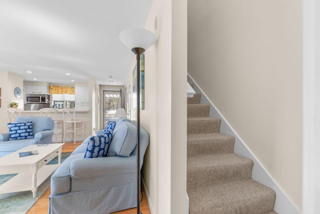 stairs featuring recessed lighting, baseboards, and wood finished floors