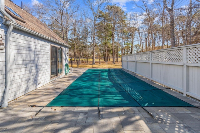 view of swimming pool featuring a patio and a fenced backyard