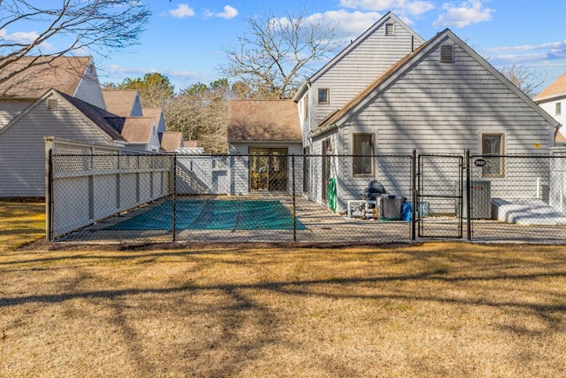 view of pool with a gate, a lawn, and fence