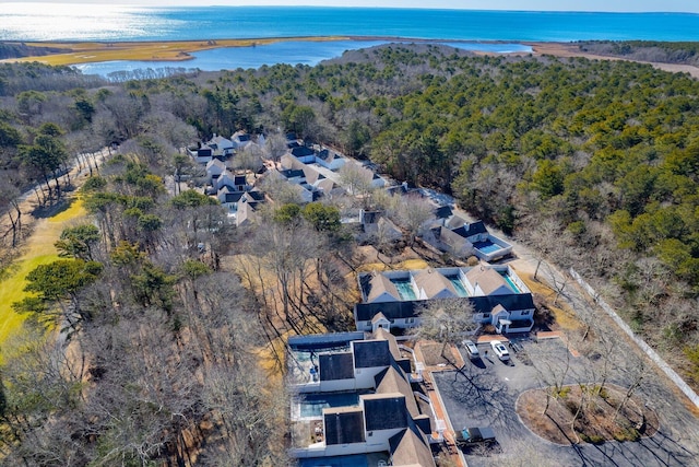 aerial view with a water view and a forest view