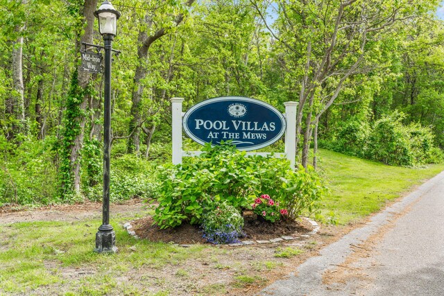 100 Mid-Iron Way Unit 7021, Mashpee, MA 02649 - view of front facade featuring a shingled roof, fence, and a pergola