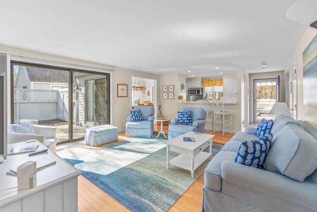 living room with recessed lighting and light wood-style floors