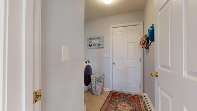 doorway to outside with a baseboard heating unit and washer / clothes dryer