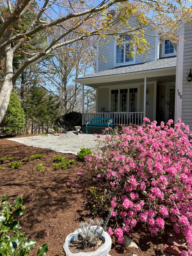 view of side of property with a porch