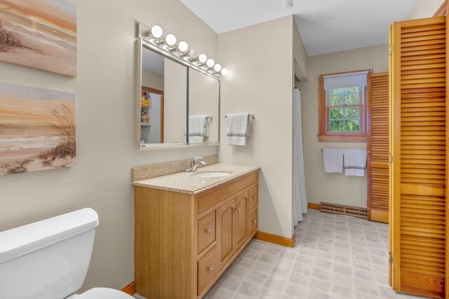 11 Joe Lincoln Rd, West Harwich, MA 02671 - bathroom with visible vents, baseboards, toilet, and vanity