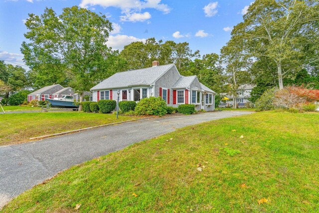 11 Joe Lincoln Rd, West Harwich, MA 02671 - ranch-style house with aphalt driveway, a chimney, and a front yard