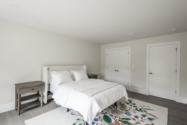 bedroom with wood-type flooring