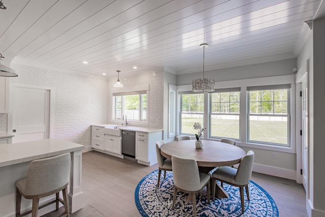 dining room featuring wooden ceiling, sink, brick wall, and light wood-type flooring