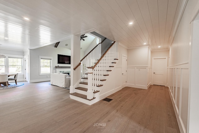 staircase with hardwood / wood-style flooring, ceiling fan, and wood ceiling