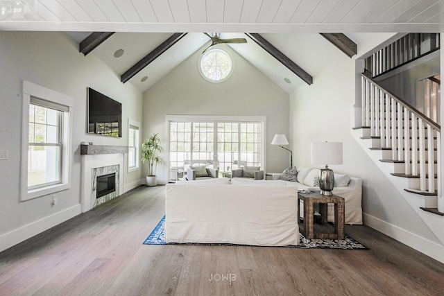 bedroom with multiple windows, hardwood / wood-style floors, and lofted ceiling with beams