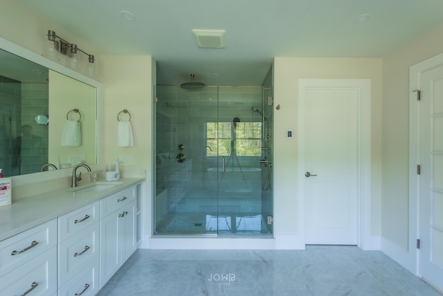 bathroom featuring vanity and an enclosed shower