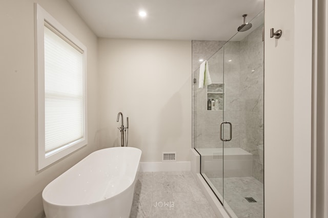 bathroom featuring shower with separate bathtub and plenty of natural light