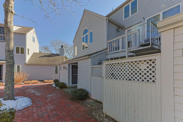 exterior space with fence and a balcony