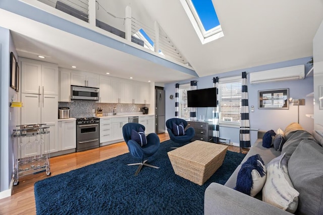 living area with a skylight, high vaulted ceiling, an AC wall unit, a baseboard heating unit, and light wood-style floors