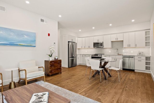 50 Nelson Ave Unit 4, Provincetown, MA 02657 - kitchen featuring stainless steel appliances, wood finished floors, white cabinets, and recessed lighting