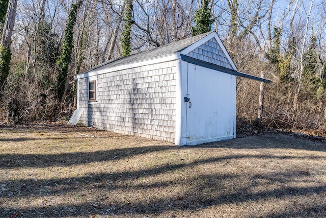 view of outbuilding featuring a yard