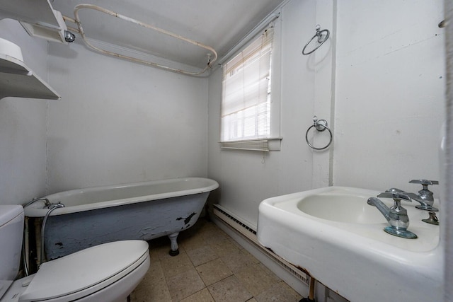 bathroom featuring a tub, sink, and toilet