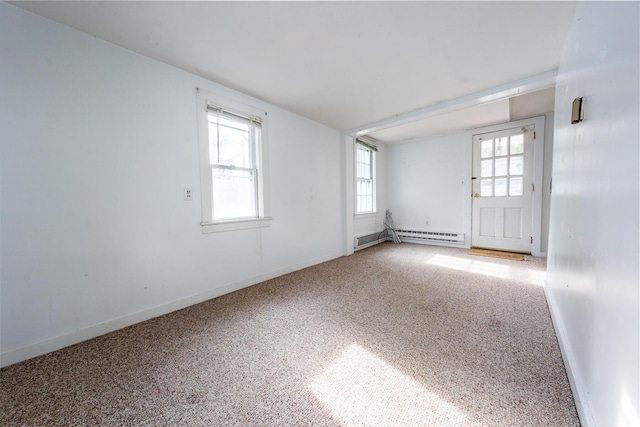 carpeted empty room with lofted ceiling and a baseboard heating unit