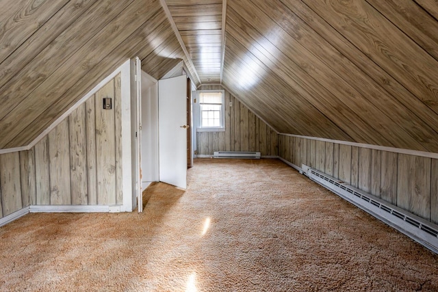 bonus room with a baseboard radiator, wooden walls, and vaulted ceiling