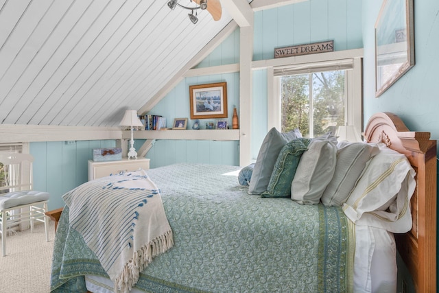 carpeted bedroom with vaulted ceiling with beams