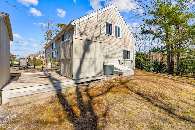 view of home's exterior featuring central AC unit and a wooden deck