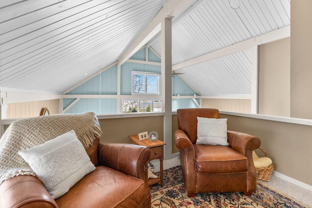 living area with vaulted ceiling with beams, baseboards, and carpet floors