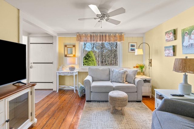 living area with hardwood / wood-style flooring and a ceiling fan