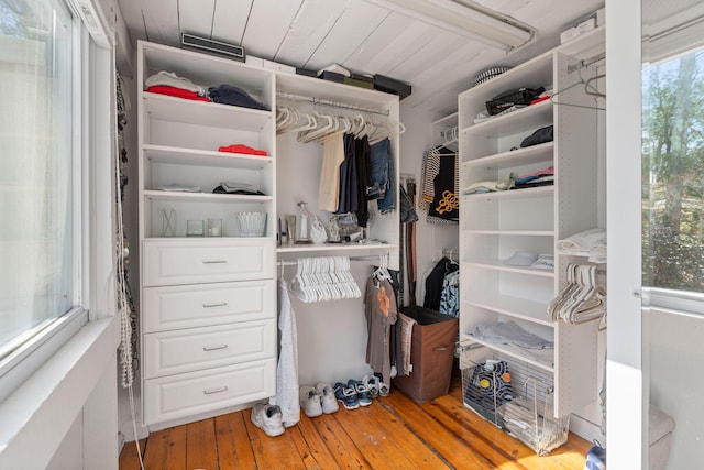 walk in closet with light wood-style flooring