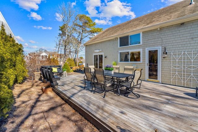 wooden terrace with outdoor dining space