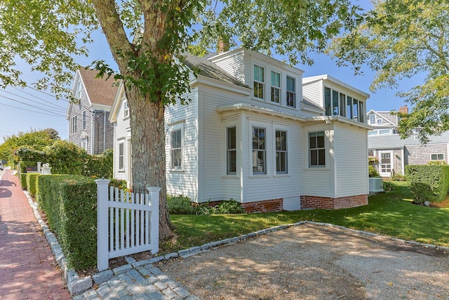 view of side of home with a lawn