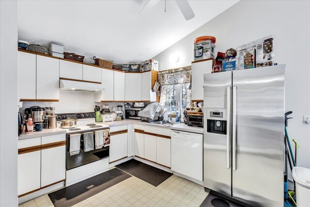 kitchen featuring sink, white appliances, white cabinetry, and vaulted ceiling