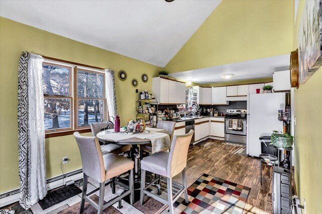 dining area with dark wood-type flooring, a baseboard radiator, and vaulted ceiling