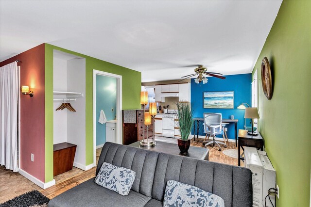 living room featuring ceiling fan and light wood-type flooring