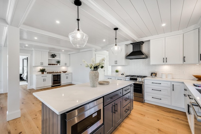 kitchen with beverage cooler, white cabinets, stainless steel appliances, wall chimney range hood, and open shelves