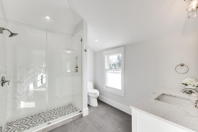 full bath with toilet, vanity, baseboards, vaulted ceiling, and a shower stall