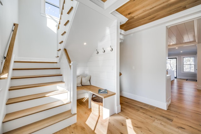 stairs featuring recessed lighting, wood finished floors, wood ceiling, and baseboards