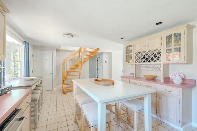 37 Old Salem Way, Osterville, MA 02655 - kitchen featuring light countertops, glass insert cabinets, and light tile patterned flooring
