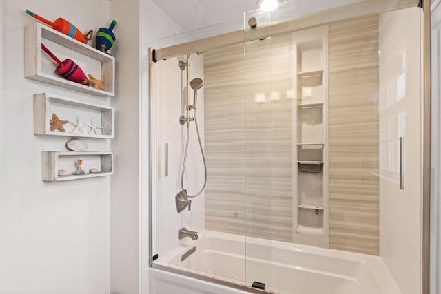 bathroom with shower / bath combination with glass door