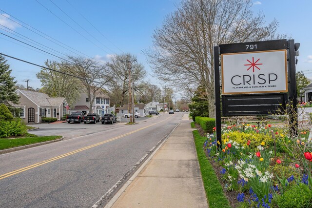 view of street with a residential view, curbs, and sidewalks