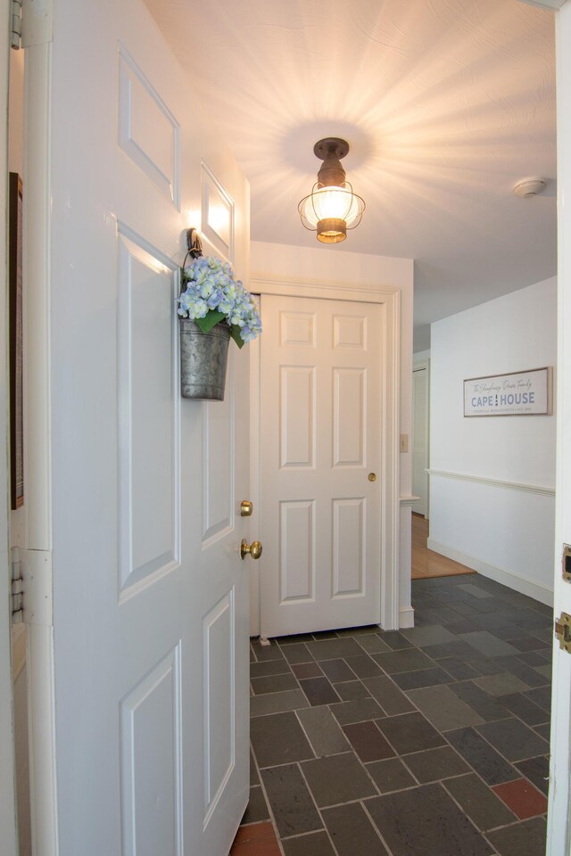 doorway featuring baseboards