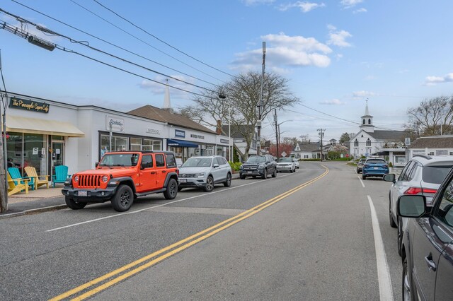 view of road with sidewalks, curbs, and street lights