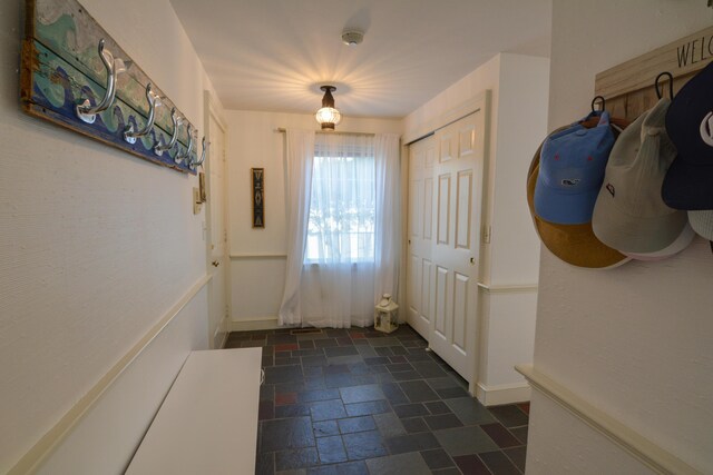 doorway with stone tile floors