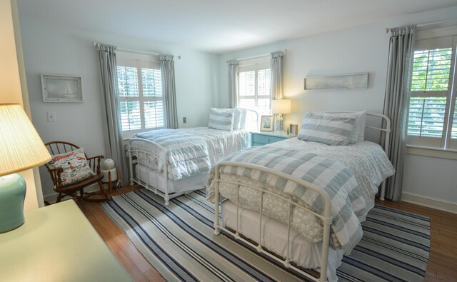 bedroom with wood finished floors and baseboards